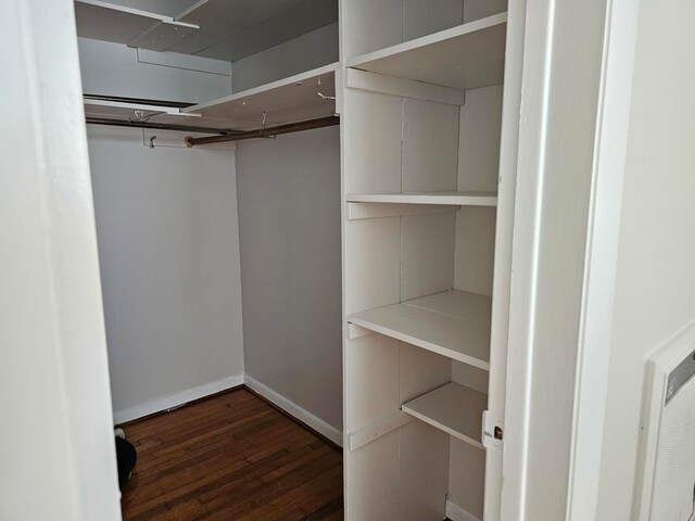 walk in closet featuring dark hardwood / wood-style floors