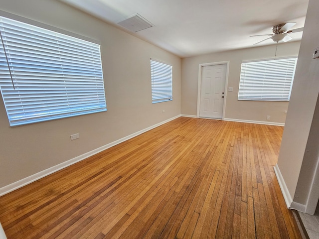 spare room with hardwood / wood-style floors and ceiling fan