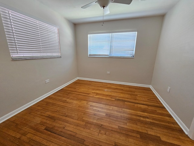 unfurnished room with ceiling fan and wood-type flooring