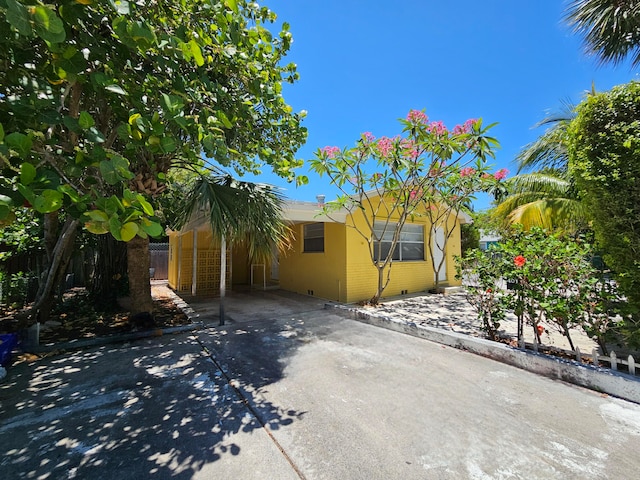 view of side of home with a carport