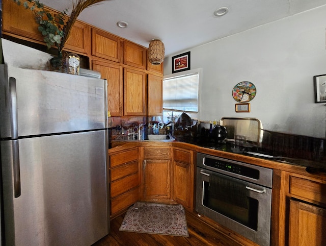 kitchen featuring appliances with stainless steel finishes and dark wood-type flooring