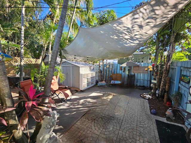 view of terrace with a storage shed