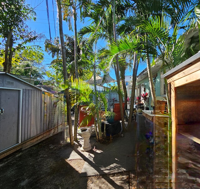 view of patio featuring a storage unit