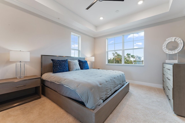 bedroom featuring a tray ceiling, ceiling fan, and light colored carpet