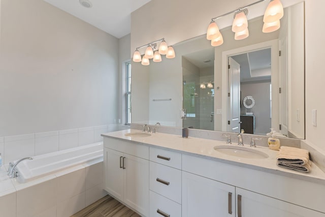 bathroom featuring shower with separate bathtub, vanity, and hardwood / wood-style flooring