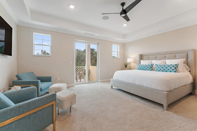 bedroom featuring carpet flooring, ceiling fan, access to exterior, and a tray ceiling