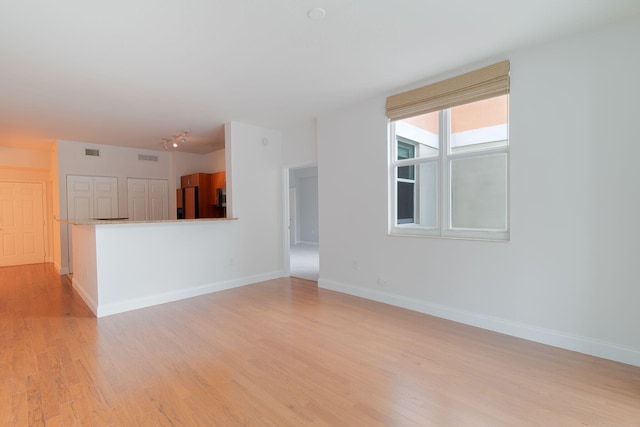 unfurnished living room featuring light hardwood / wood-style floors