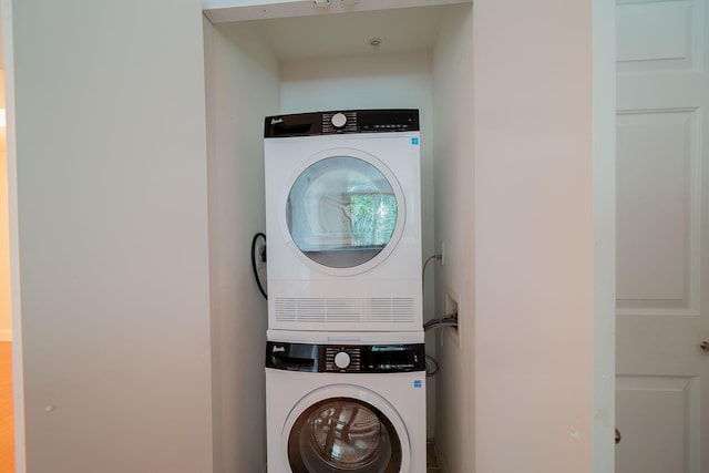 laundry room with stacked washer / dryer and hookup for a washing machine