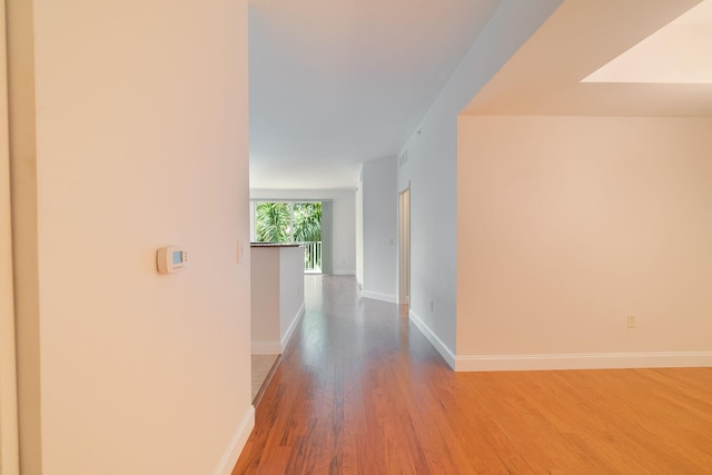 hallway with hardwood / wood-style floors