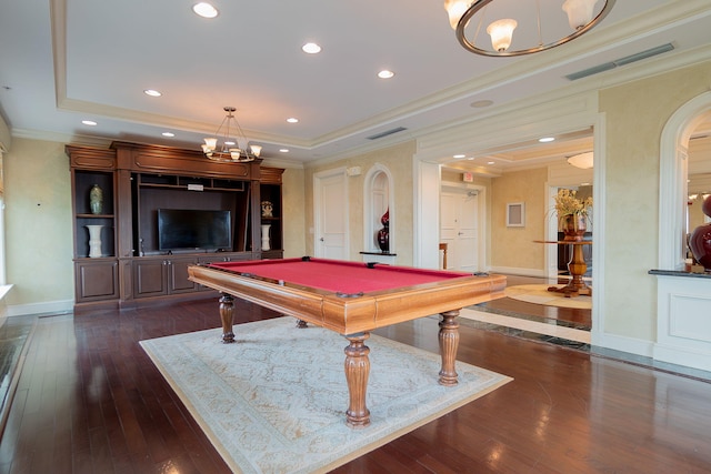 game room with dark hardwood / wood-style flooring, billiards, a raised ceiling, and ornamental molding