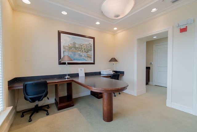 carpeted office space with a raised ceiling and ornamental molding