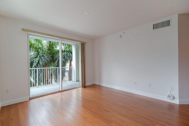 empty room with light hardwood / wood-style flooring