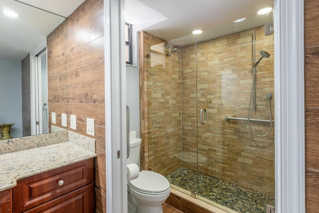 bathroom featuring vanity, toilet, and an enclosed shower