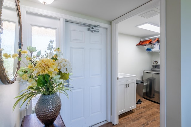 washroom featuring hardwood / wood-style floors and washer / clothes dryer