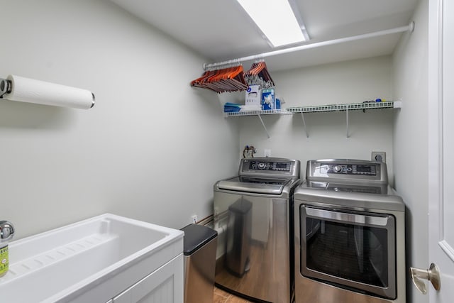 clothes washing area featuring separate washer and dryer and hardwood / wood-style floors