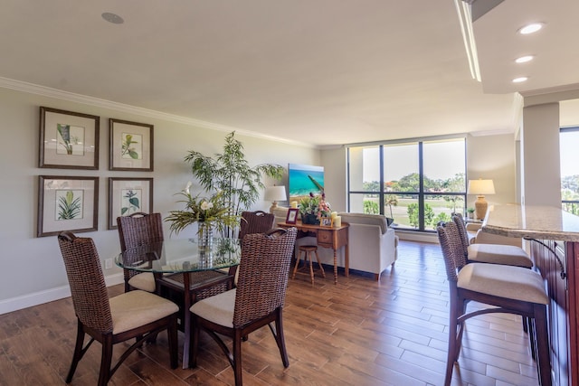 dining space with dark hardwood / wood-style flooring and ornamental molding