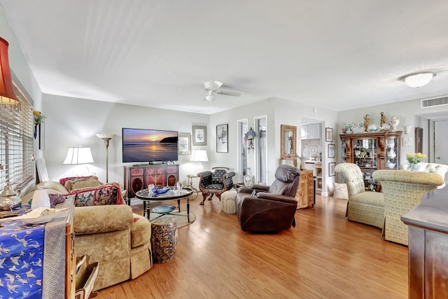 living room featuring ceiling fan and light wood-type flooring