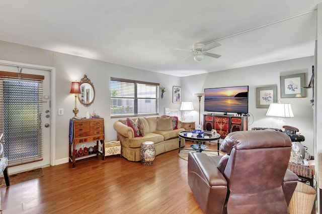 living room featuring hardwood / wood-style floors and ceiling fan