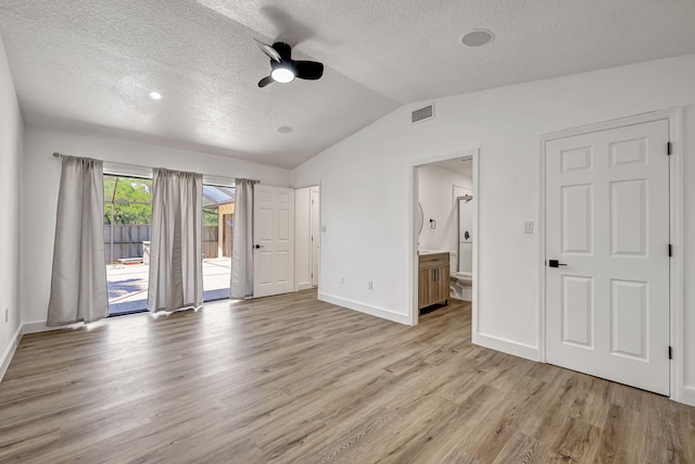 unfurnished bedroom featuring connected bathroom, ceiling fan, access to exterior, light hardwood / wood-style floors, and lofted ceiling