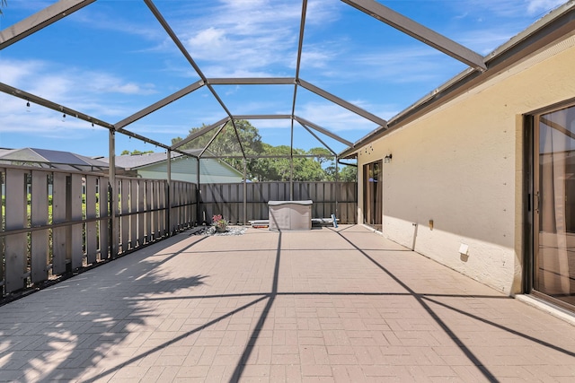 view of patio with glass enclosure