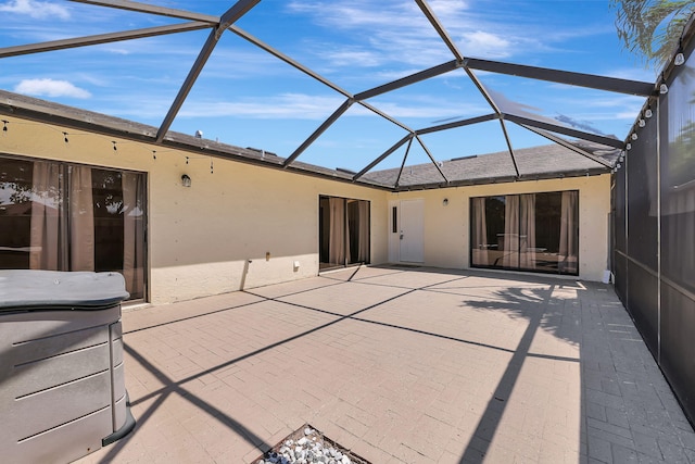 back of property with a lanai and a patio