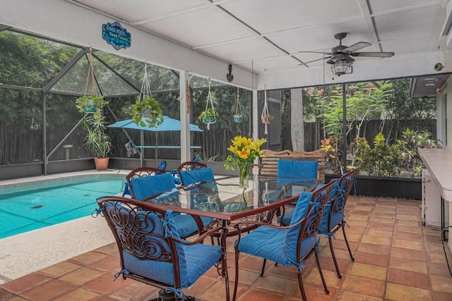 view of swimming pool featuring a patio, ceiling fan, and a lanai