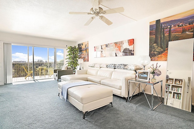 living room featuring dark colored carpet, a textured ceiling, and ceiling fan