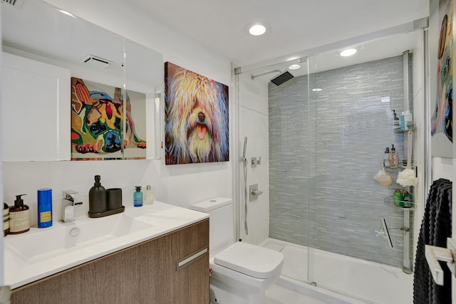 bathroom featuring vanity, toilet, and an enclosed shower