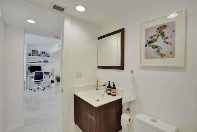 bathroom with vanity and toilet