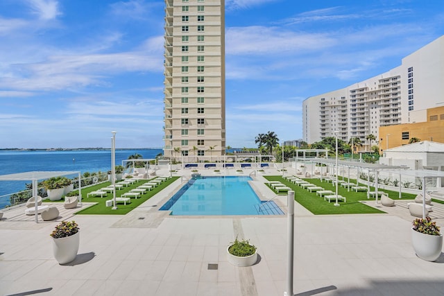 view of pool featuring a patio and a water view