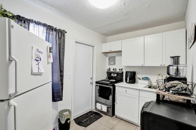 kitchen with a textured ceiling, white cabinets, stainless steel range with electric cooktop, white refrigerator, and light tile patterned floors