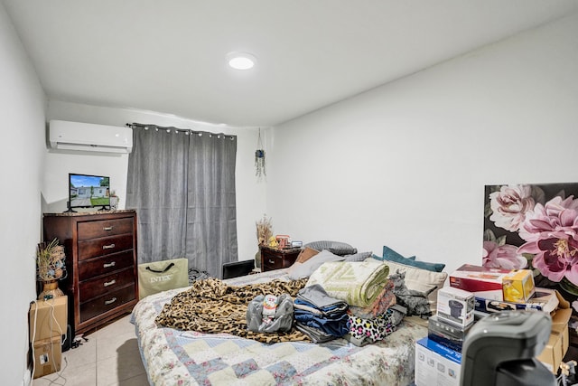 bedroom featuring a wall unit AC and light tile patterned flooring