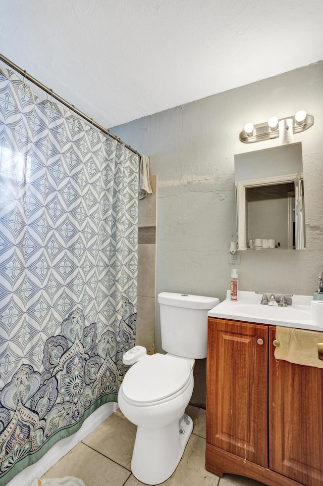 bathroom featuring tile patterned floors, vanity, and toilet