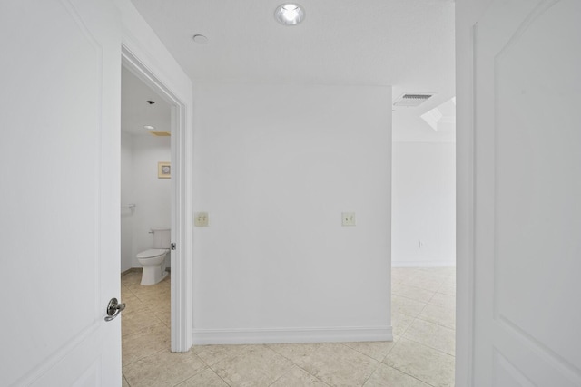 bathroom with tile patterned flooring and toilet