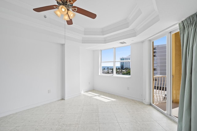 unfurnished room with ceiling fan, ornamental molding, light tile patterned floors, and a tray ceiling