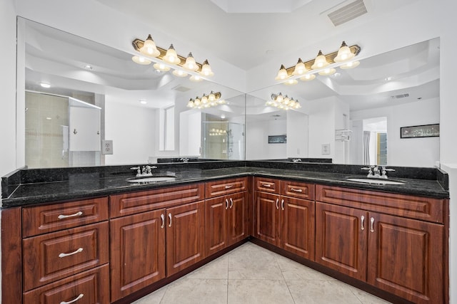 bathroom featuring a tray ceiling, tile patterned flooring, vanity, and an enclosed shower