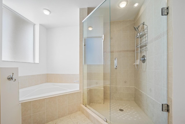 bathroom with tile patterned floors and independent shower and bath