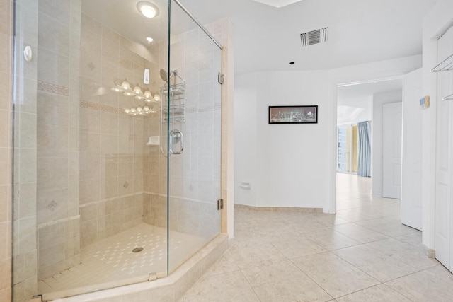 bathroom featuring tile patterned floors and a shower with door