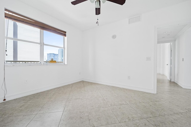 unfurnished room with ceiling fan and light tile patterned floors