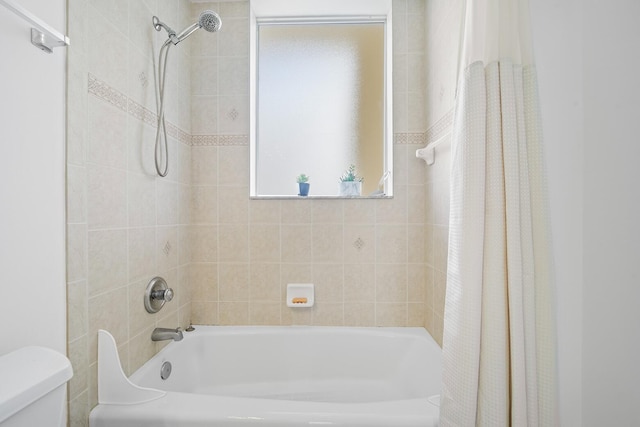 bathroom with toilet and shower / bathtub combination with curtain