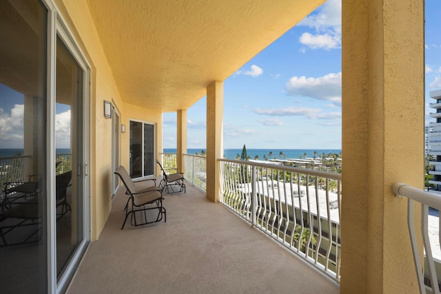 balcony featuring a water view