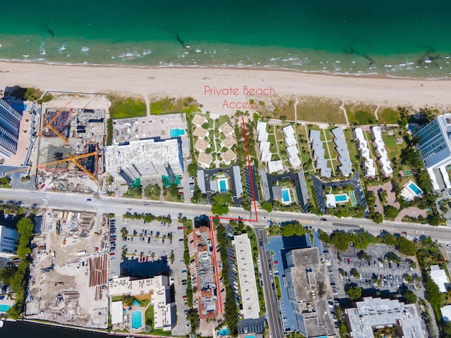 aerial view with a water view and a view of the beach