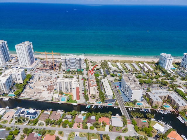 drone / aerial view featuring a beach view and a water view