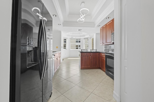 kitchen featuring kitchen peninsula, appliances with stainless steel finishes, ornamental molding, a tray ceiling, and light tile patterned floors