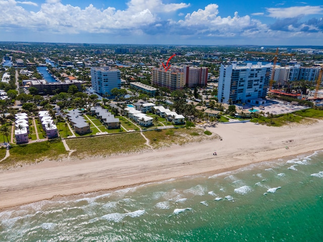 bird's eye view with a water view and a view of the beach