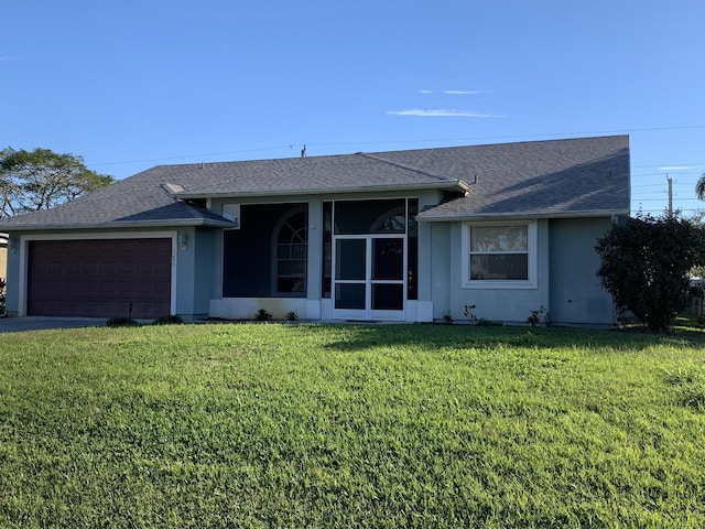 single story home featuring a front yard and a garage