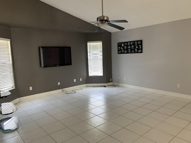 spare room with plenty of natural light, ceiling fan, light tile patterned floors, and lofted ceiling