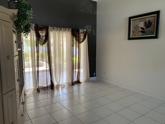 unfurnished room with light tile patterned floors