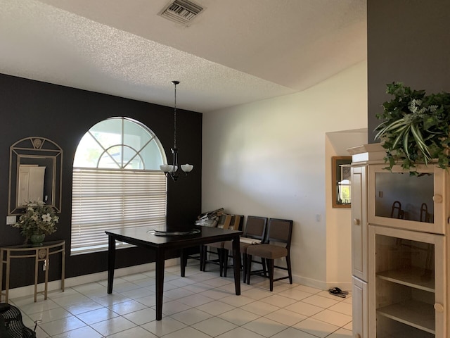 home office with light tile patterned floors and a textured ceiling