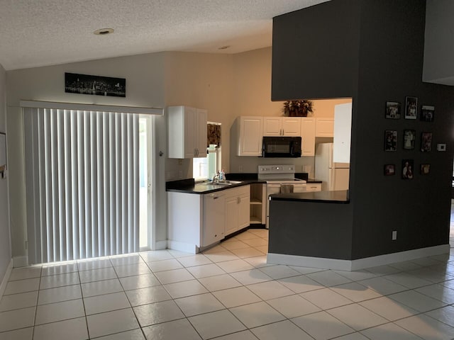 kitchen featuring lofted ceiling, white cabinetry, light tile patterned floors, and white appliances